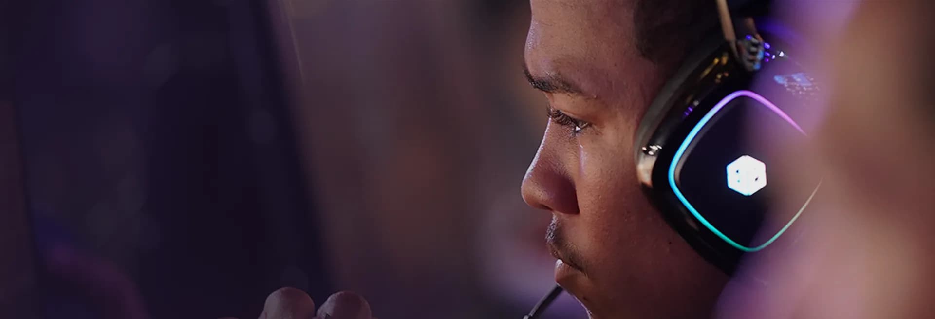 An esports competitor focused at their station